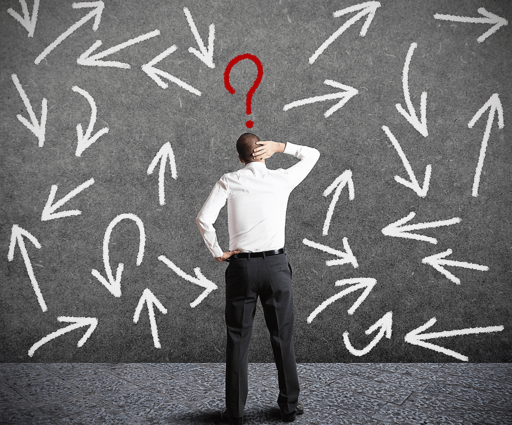 Person standing with a question mark over his head in front of a blackboard of arrows in different directions