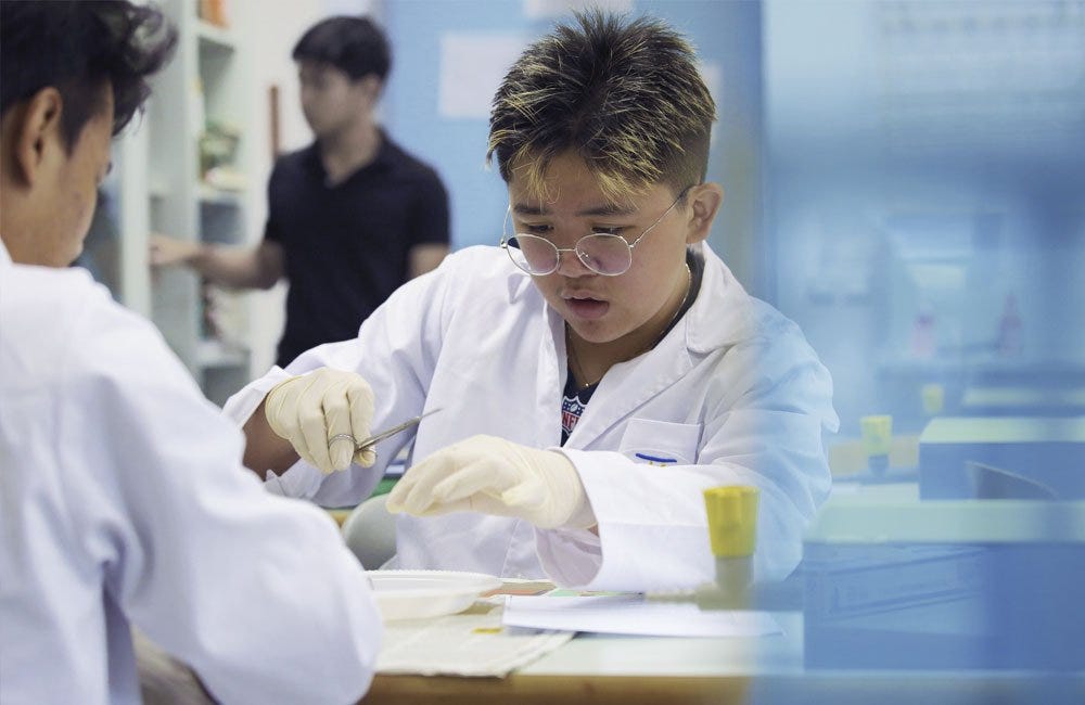 Biology students dissecting cow eyes at the German School Jakarta