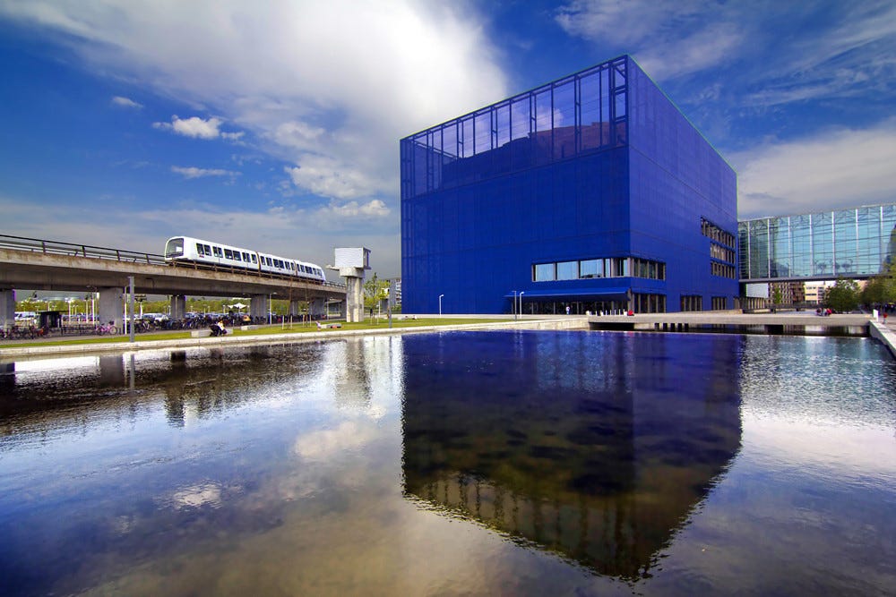 Jean Nouvel’s blue DR Koncerthuset with passing metro car