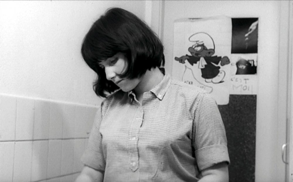 Still from the 1968 film “Blow Up My Town,” directed by Chantal Akerman. Black and white, a woman with dark hair looking down