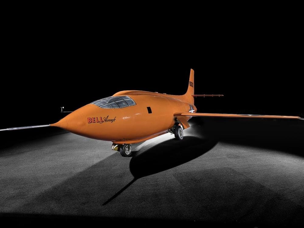Photo of the orange X-1 experimental aircraft by Bell.
