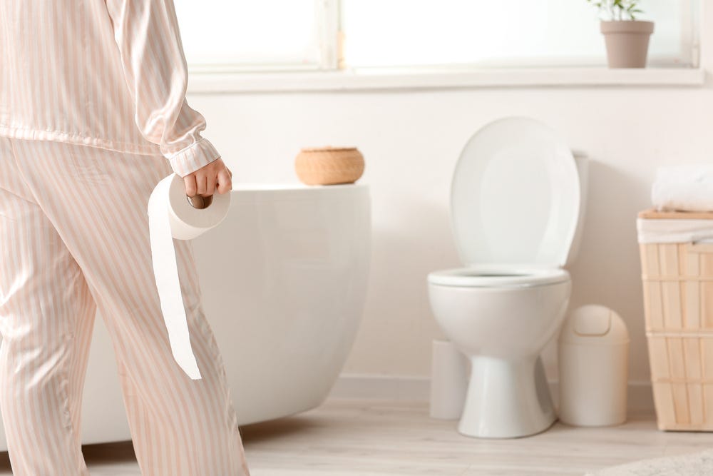 Woman with hemorrhoids visiting the bathroom