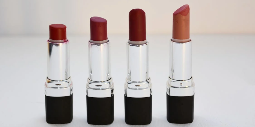 Close-up image of a lipstick with a sleek, modern design on a neutral background. The lipstick tube is partially open, revealing a rich, vibrant shade of red. This image is used to illustrate the blog post ‘Toxic Ingredients in Lipstick to Avoid for Clean Beauty,’ highlighting the importance of avoiding harmful chemicals in cosmetics for healthier, cleaner beauty options.