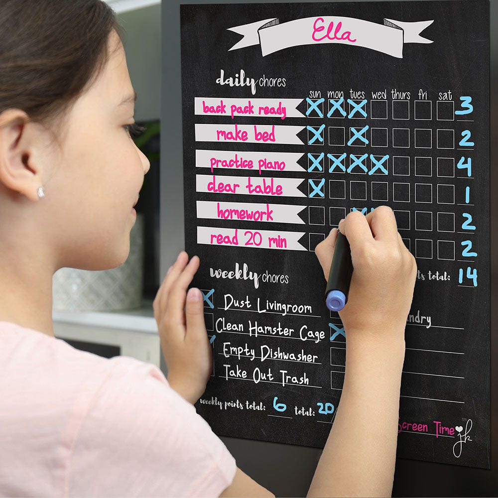 A girl filling a chore chart