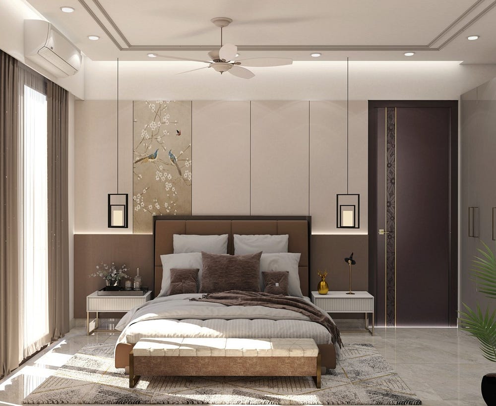 This modern bedroom design exudes comfort and sophistication with warm earthy tones, soft textures, and elegant detailing. A plush upholstered bed sits at the center, flanked by sleek nightstands and pendant lights that add balance and charm. The feature wall showcases subtle paneling with a delicate bird-and-flower artwork, infusing a serene ambiance. Natural light through sheer curtains enhances the airy feel, while minimal décor ensures a clean, calming, and luxurious retreat.