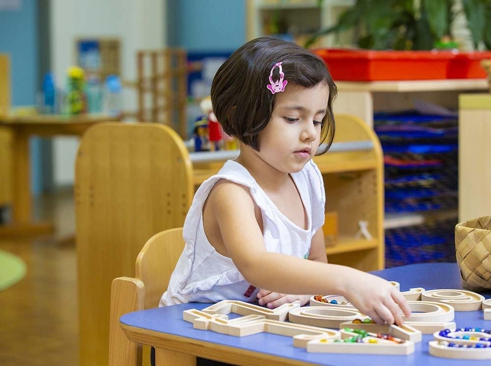 A young girl is learning through play at Deutsche Schule Jakarta