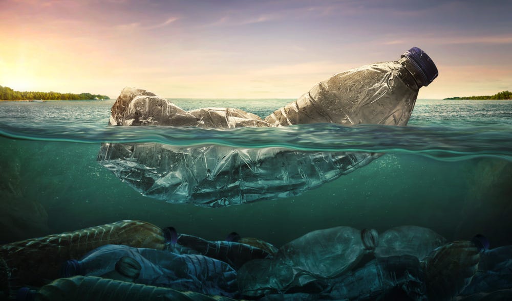 Picture: A plastic bottle floating on the water and many other bottles laying on the bottom below.