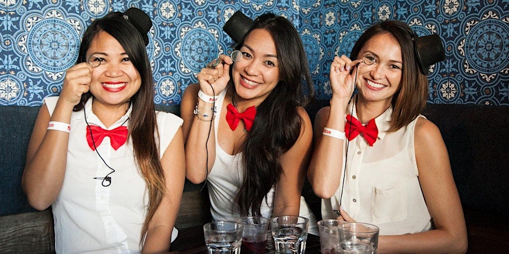 Three woman dressed in Monopoly-themed attire for the boardgame food and drinks crawl.