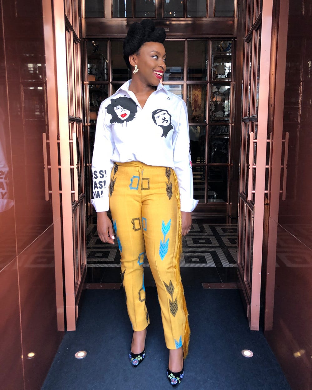 Chief Chimamanda Ngozi Adichie looking stunning in her yellow Akwete trousers