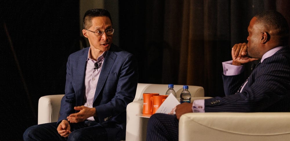 Eric Liu participates in a seated conversation on stage