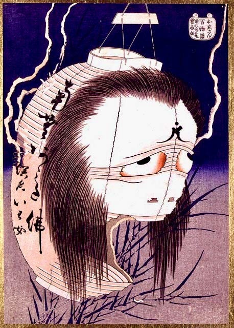 Sad faced Japanese lantern with long hair and a gaping mouth.
