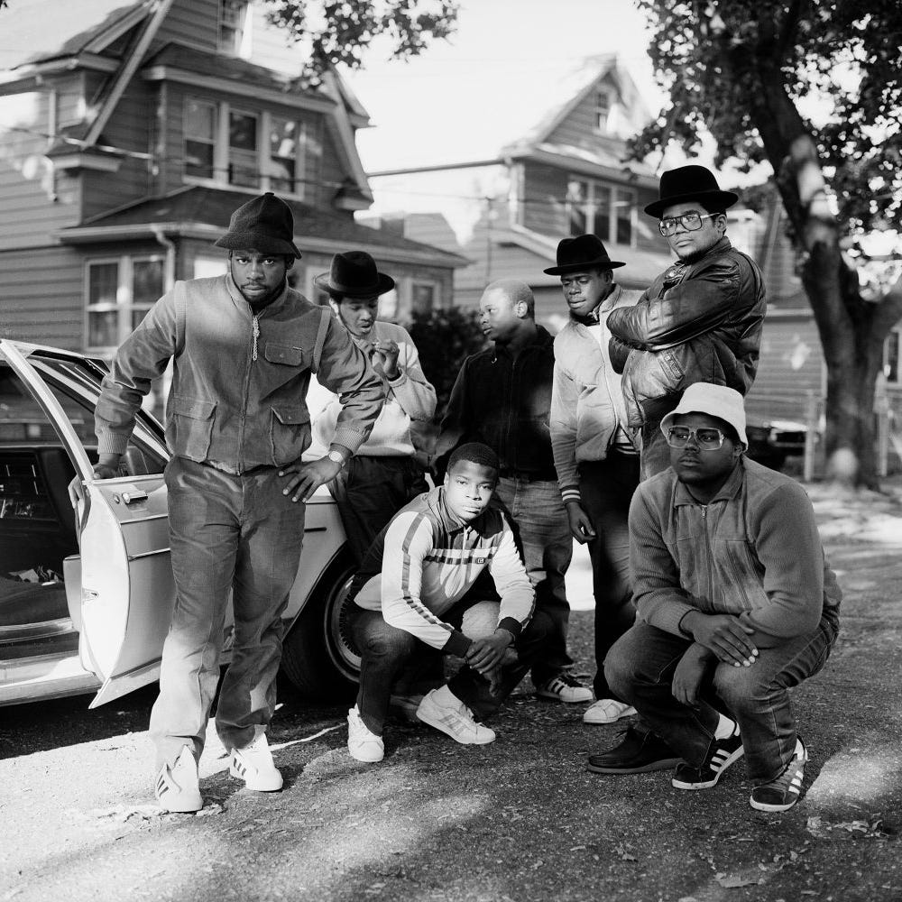 A group of hip-hop artists pose for a photograph