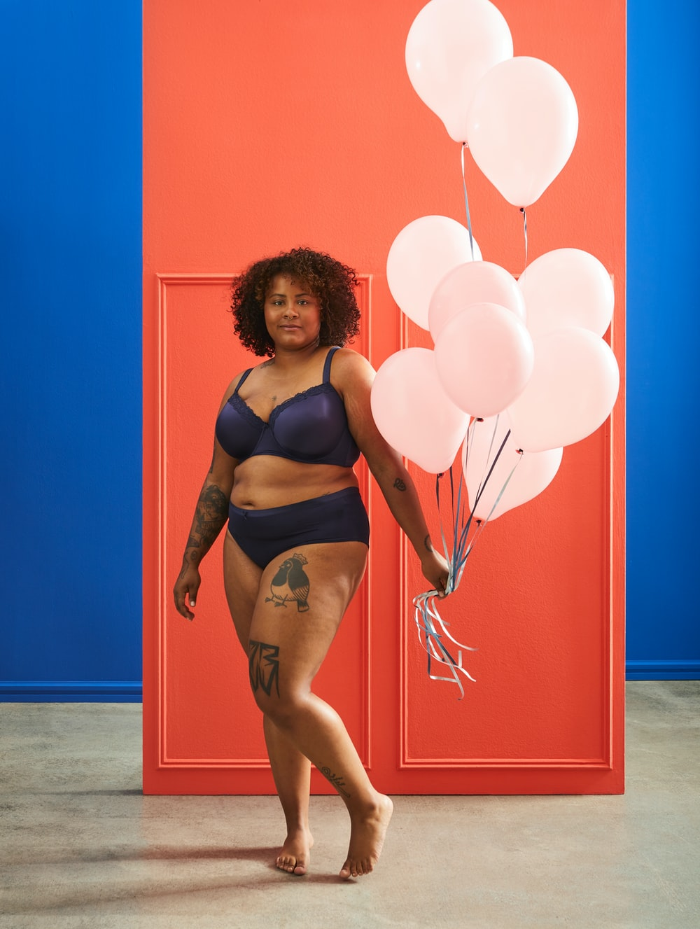 A plus-size woman holding balloons