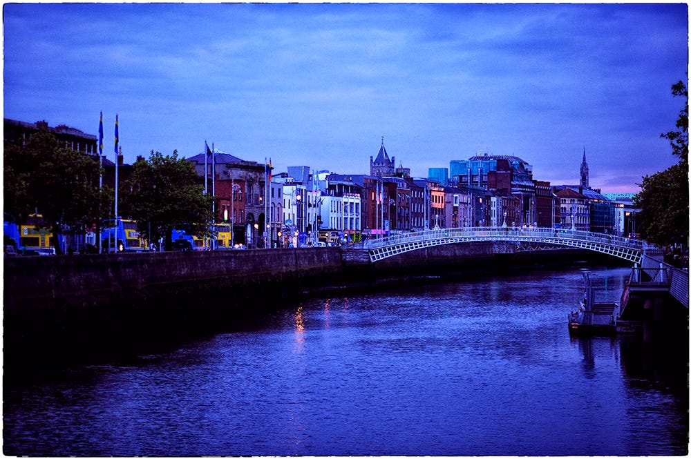 Color image of Dublin, Ireland’s Liffey River and Ha’penny Bridge at dusk