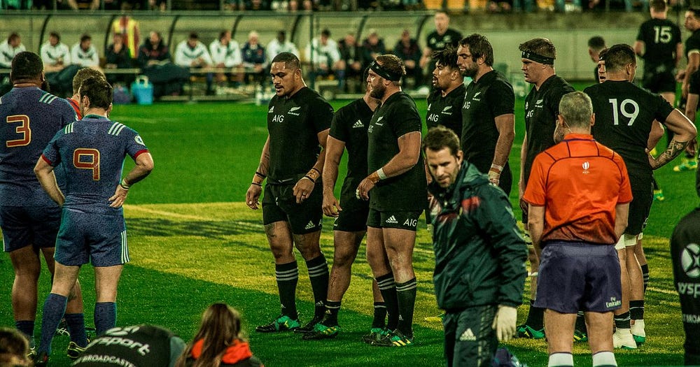 The All Blacks frontrow is preparing for a scrum