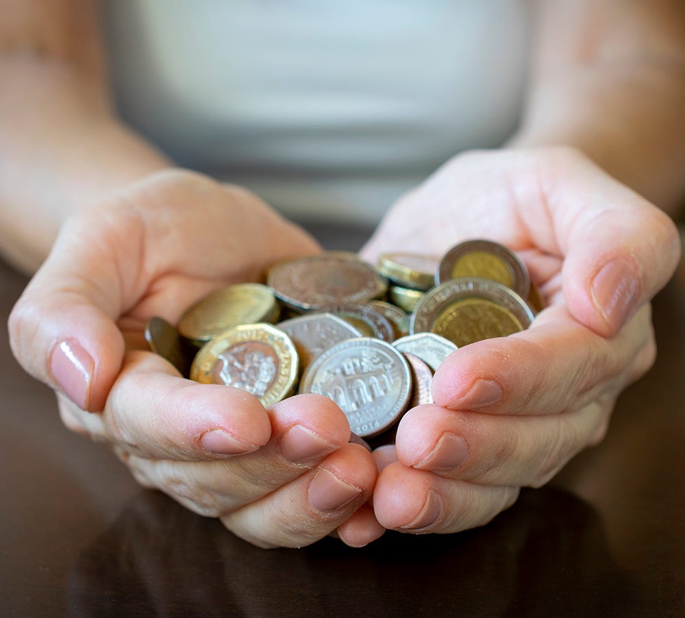 Hands holding coins