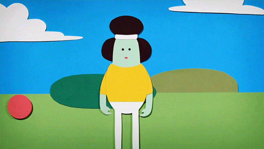 A cartoon character with a round headband holds a red ball, standing on grass with hills and a cloud in the background. The scene is bright and playful.