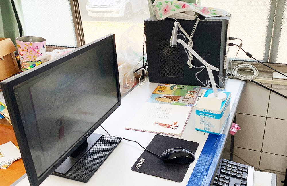 A refurbished P2V document camera easily set up and ready to display Mandarin teaching materials.