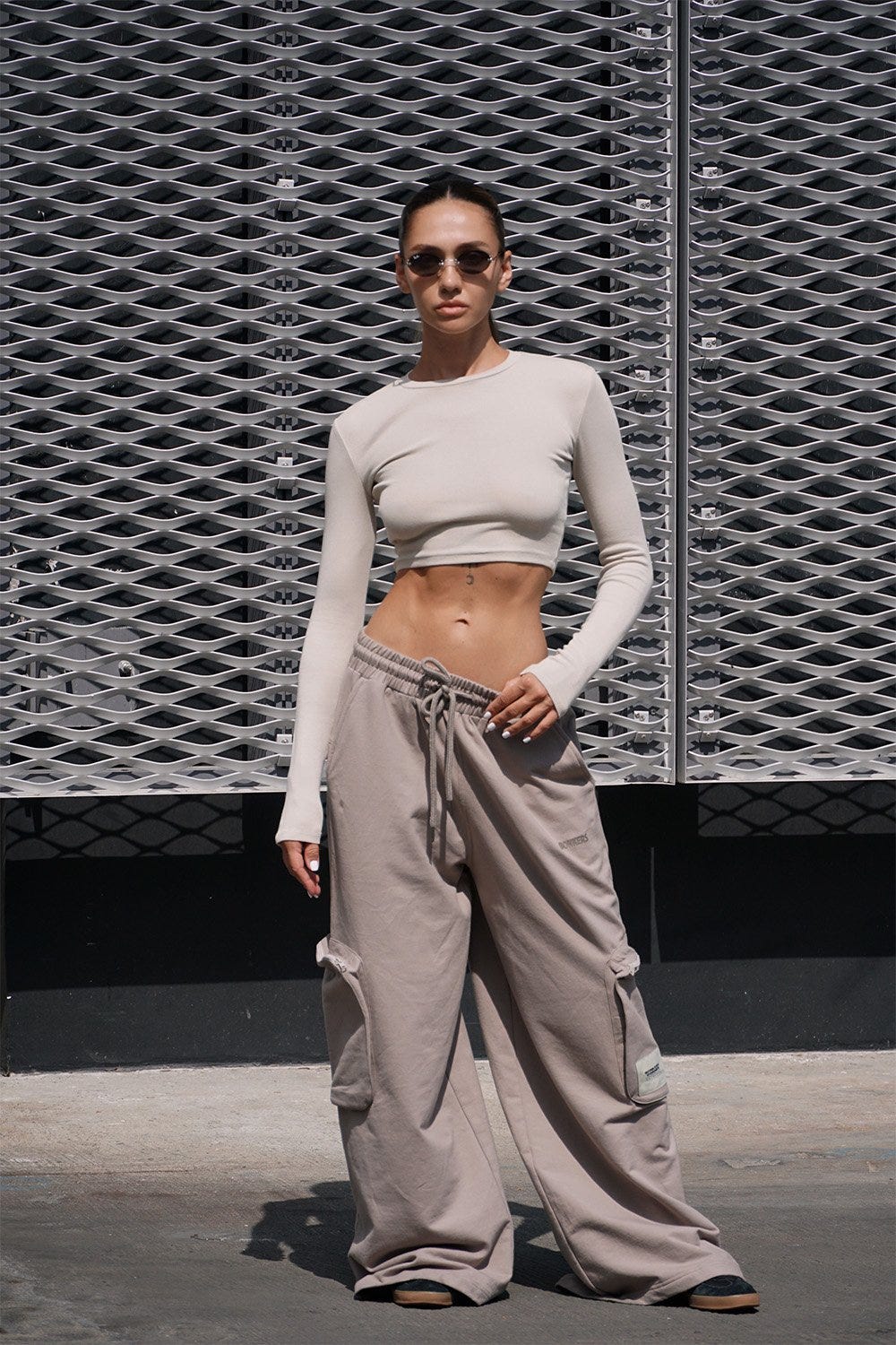 An image of a woman in a crop top and Light Beige Heavyweight Cargo Pants With Pockets by Bonkers Corner.