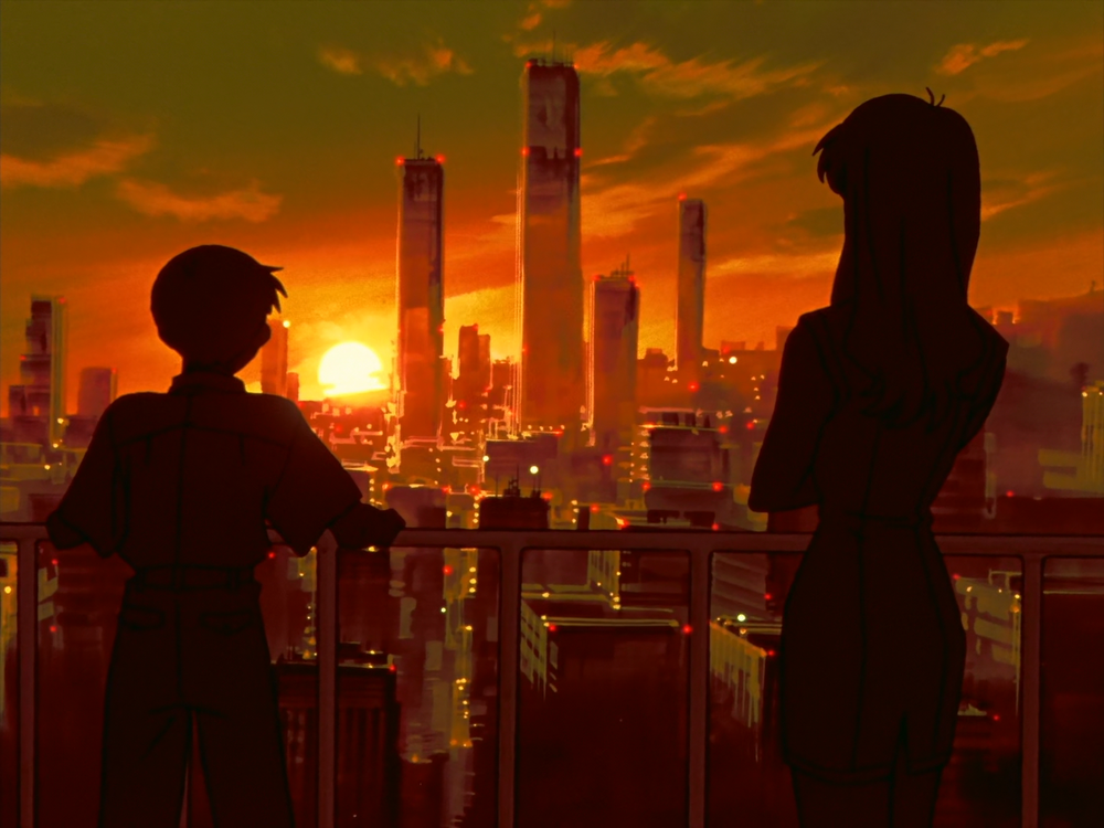 Two silhouettes, a young boy on the left and a woman with long hair on the right, stand on a balcony overlooking the sunset in Tokyo.