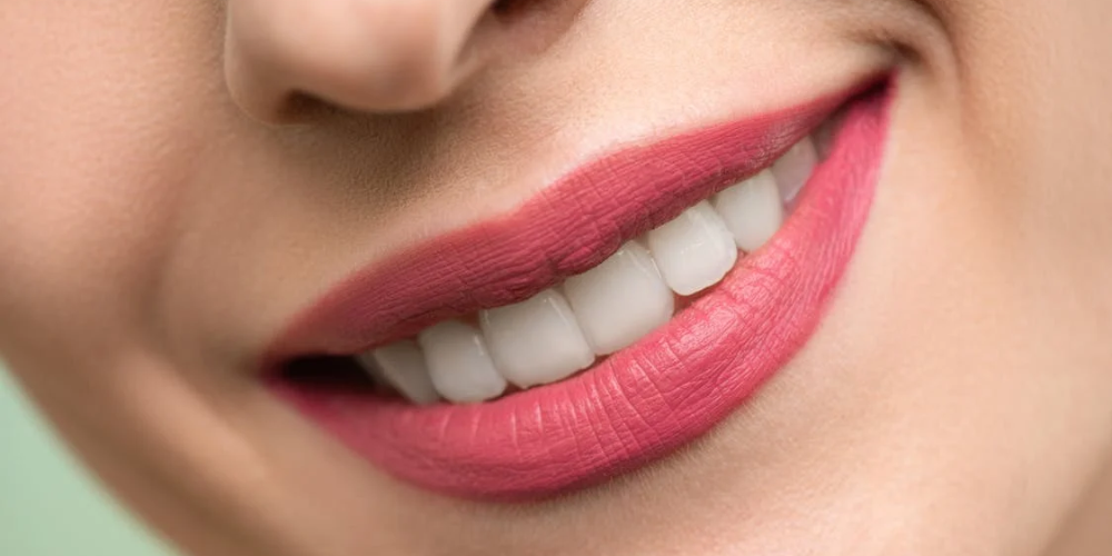 Close-up image of a lipstick with a sleek, modern design on a neutral background. The lipstick tube is partially open, revealing a rich, vibrant shade of red. This image is used to illustrate the blog post ‘Toxic Ingredients in Lipstick to Avoid for Clean Beauty,’ highlighting the importance of avoiding harmful chemicals in cosmetics for healthier, cleaner beauty options.