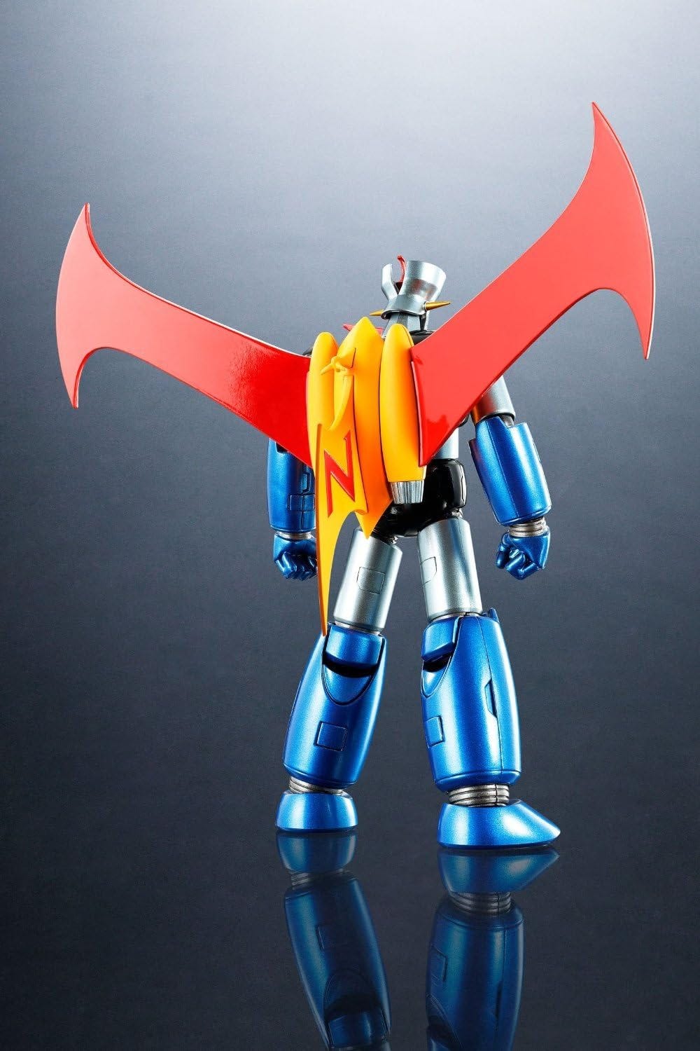 Reverse image of Mazinger Z ‘Iron Cutter’ edition action figure in a relaxed stance with hands down at its sides. The full scrander is visible.