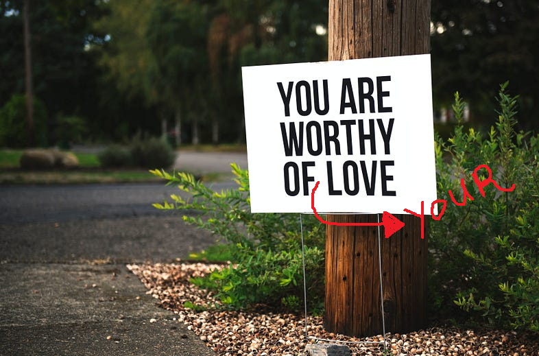 sign that reads “you are worthy of love” altered to say “you are worthy of your love”