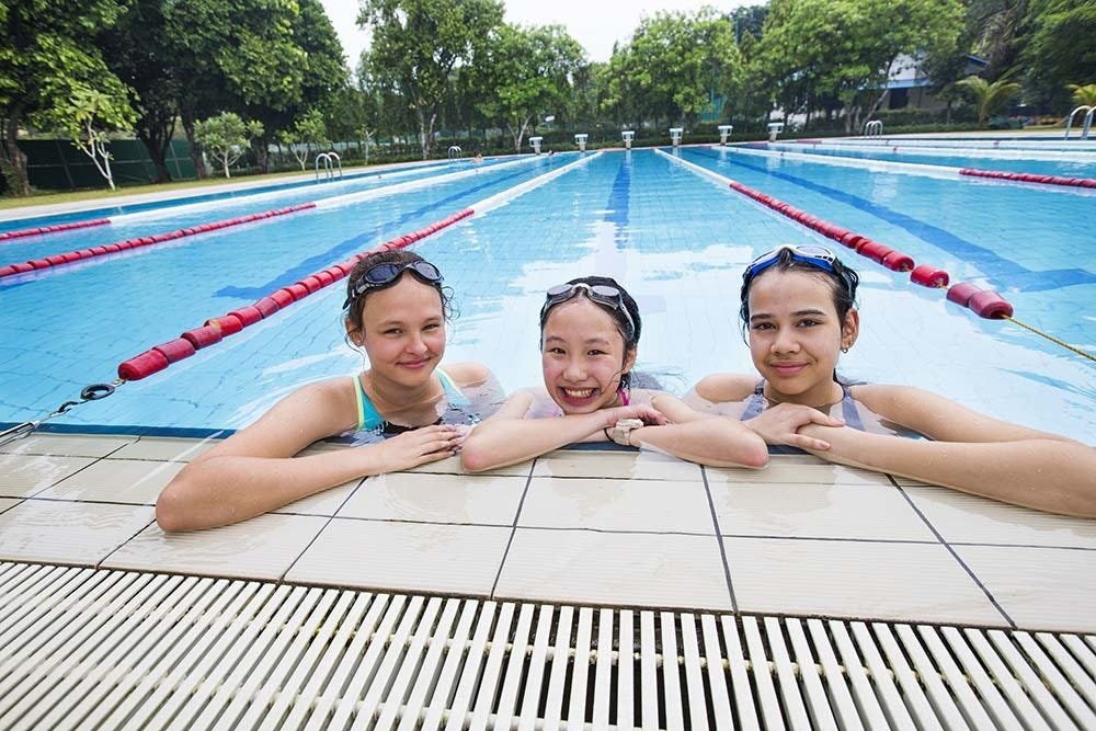 Three secondary girl students in the pool at Deutsche Schule Jakarta