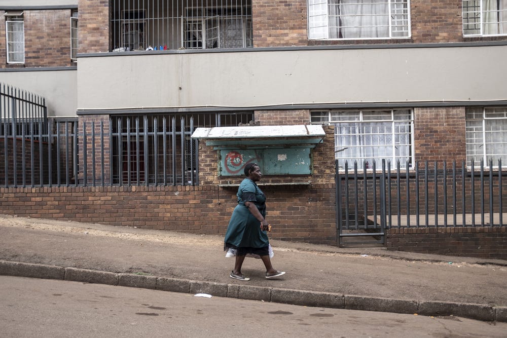 Judith Manjoro walks to the street corner where she sells Tupperware. Having established a minimal income from the school, she can afford to pay the permanent staff and bills. To supplement this, she sells Tupperware on the weekends.⁣ Photo by Miora Rajaonary