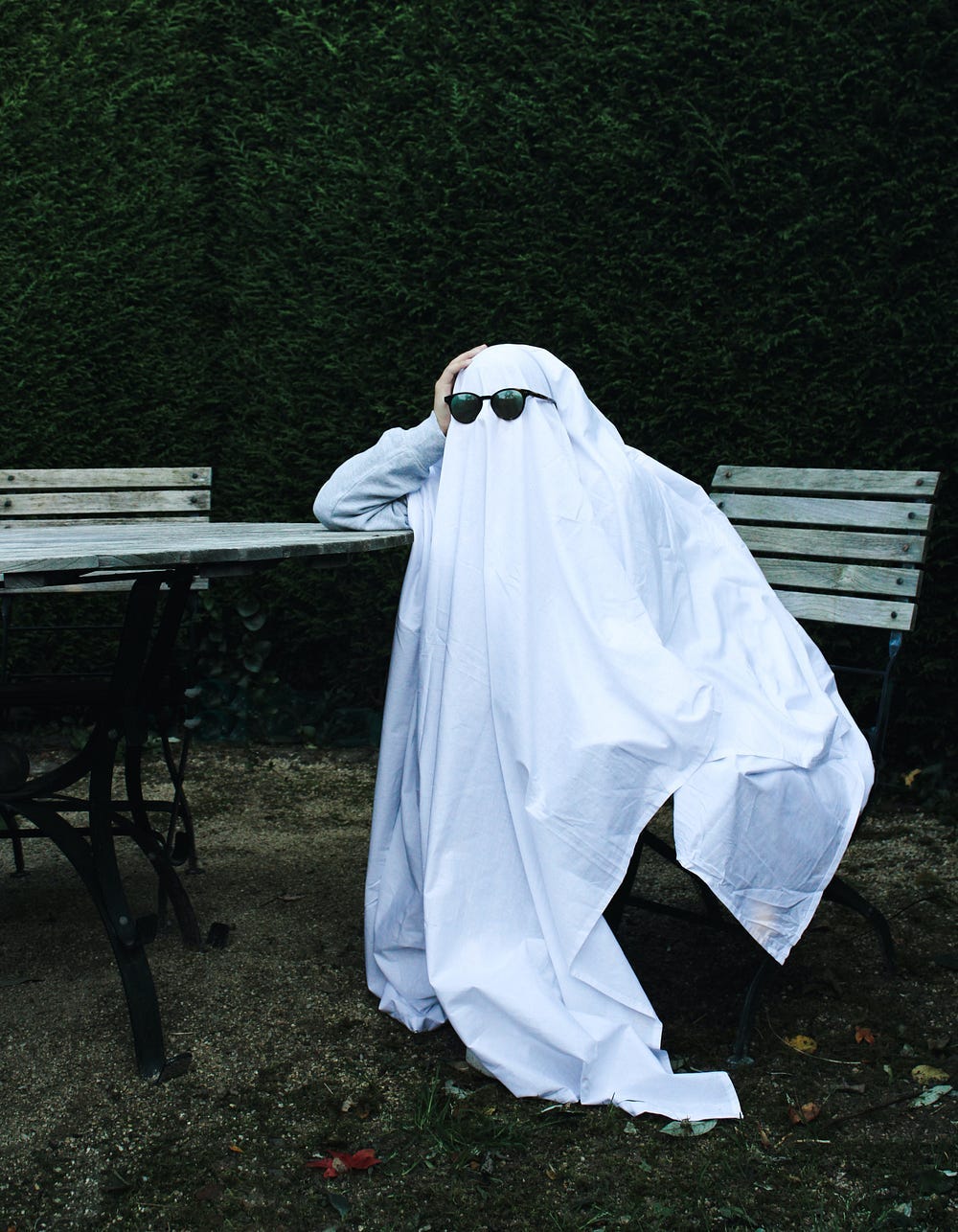 Fed up looking ghost wearing sunglasses.