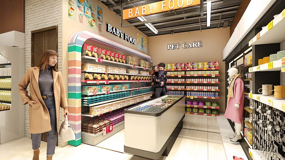 A modern supermarket aisle showcasing baby food and pet care sections. Colorful shelves filled with baby products are framed by a rainbow-patterned display. In the center, a refrigerated counter is neatly stocked. At the back, a man holds a child while browsing pet care items. On the right, shelves display mugs and kitchenware alongside a mannequin dressed in a pink coat and scarf. A woman in a tan coat carrying a handbag walks through the bright, well-organized store.
