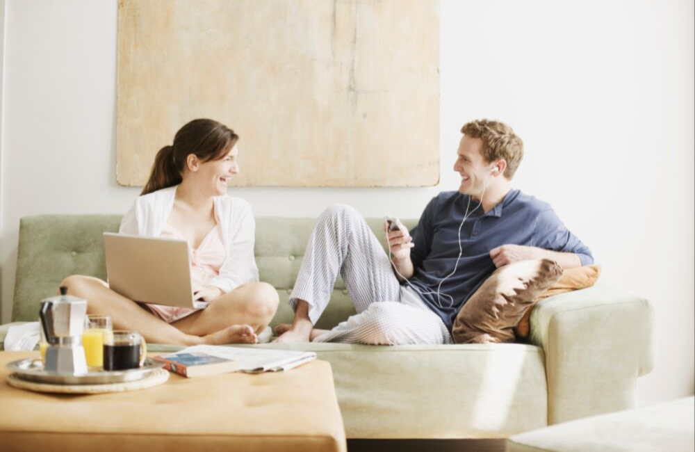 Couple spending time together on the couch. Couple discussing their finances.