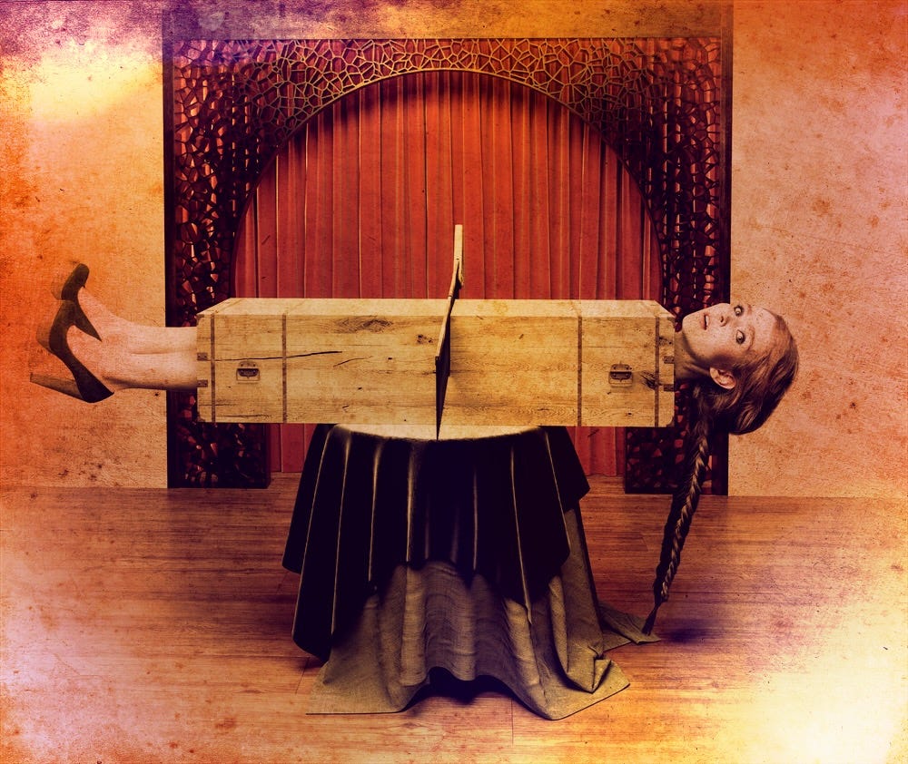 Woman in a box about to be cut in half by a magician; psychedelic medicine analogy