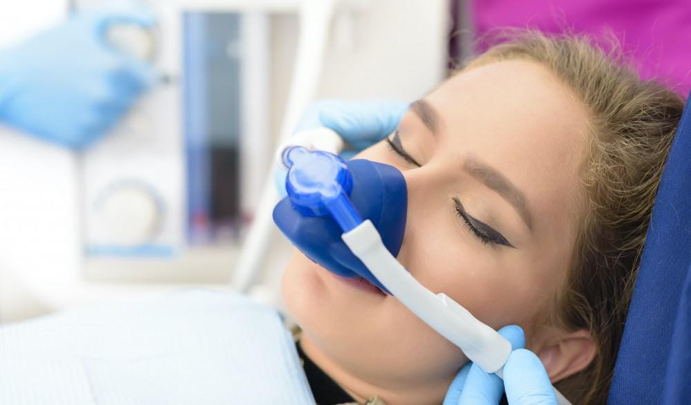 A person under general anesthesia about to get dental treatment.