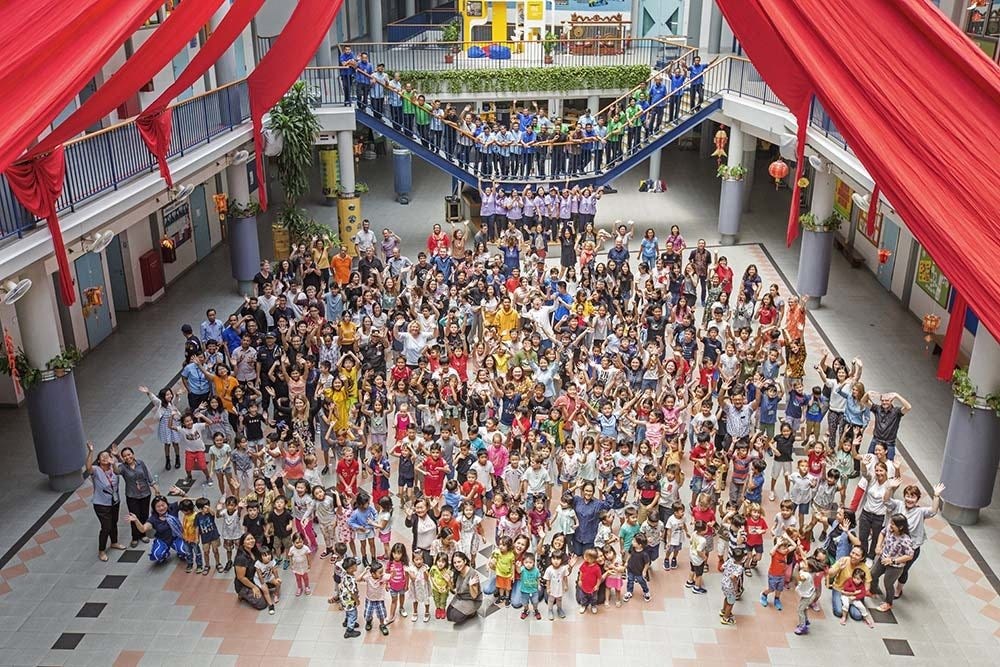 Students and teachers gather in the school hall at Deutsche Schule Jakarta