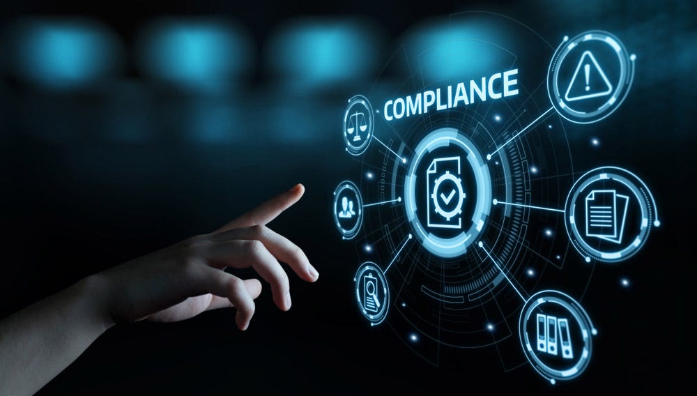 A hand pointing towards a holographic projection of the word compliance and icons