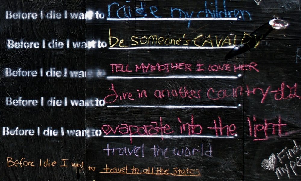 Artist Cindy Chang’s art installation of a chalkboard with responses to the question, “Before I die I want to …” Responses include: “Raise my children,” “Travel the world,” “Live in another country” and “Tell my mother I love her.”