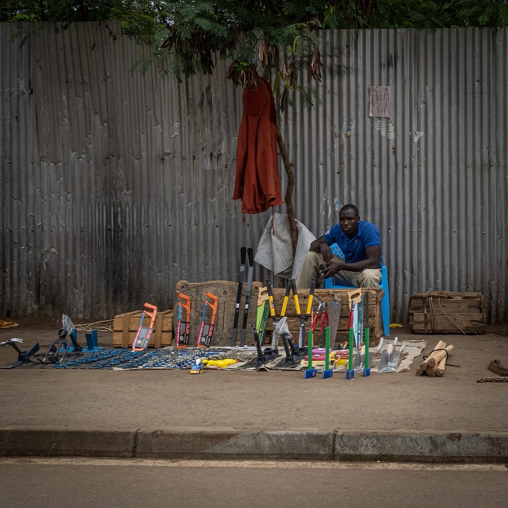 There are people selling stuff all along the sidewalks.