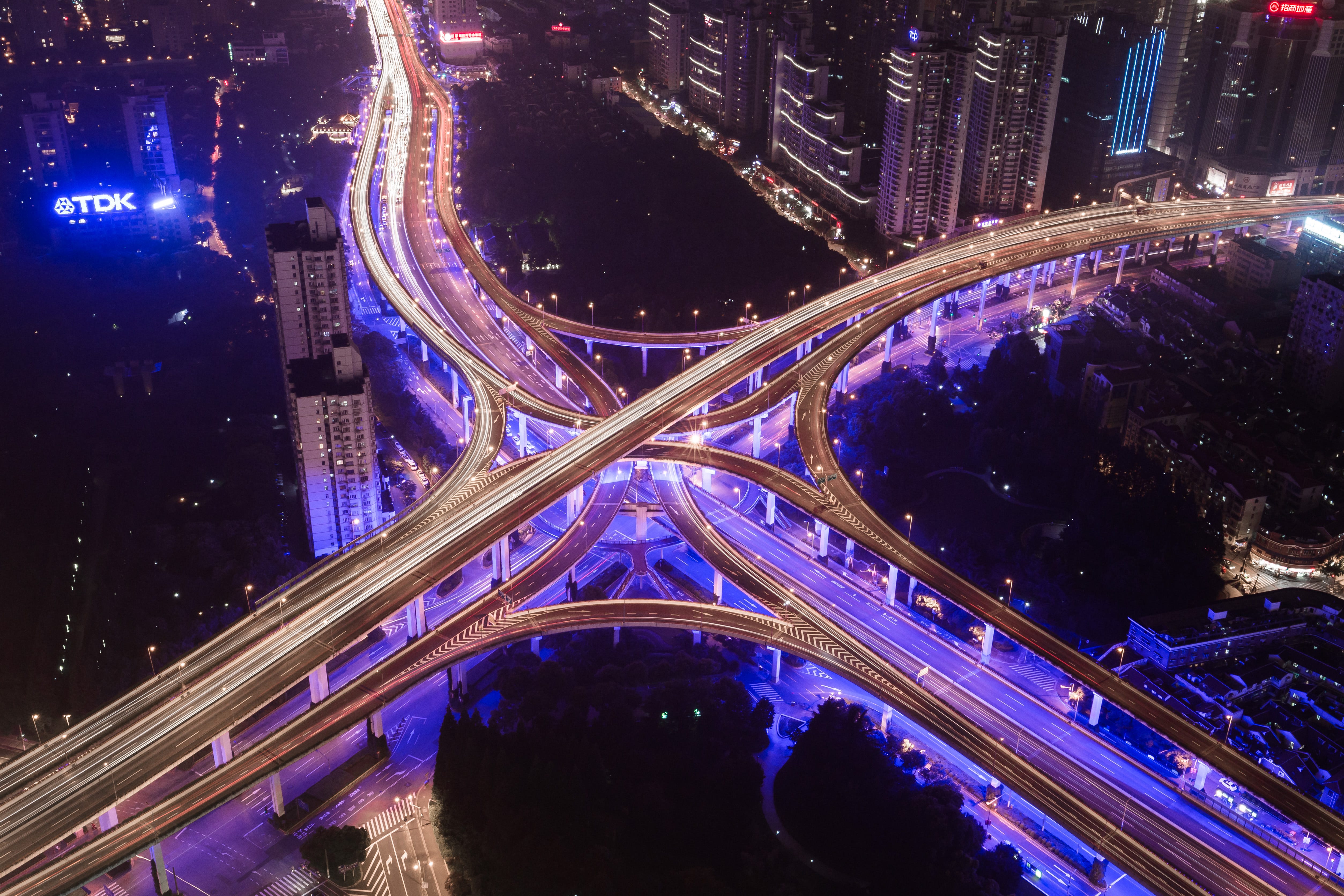 “A local interchange with purple lights and city buildings in the background” by Denys Nevozhai on Unsplash