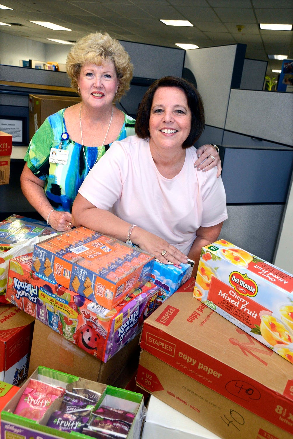 Lourdes’ Carol Lynn Wilkes (left) and Annette Gubernick gather food items to donate to Angels of God (AOG) Community Outreach Summer Food Program.