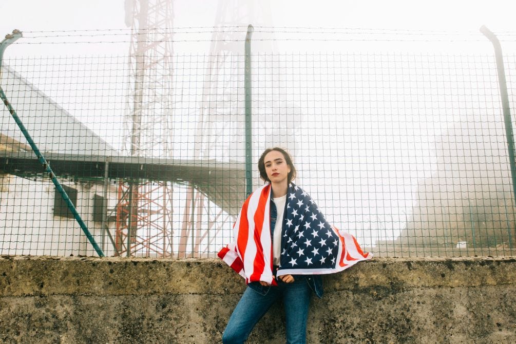 A woman who has draped herself with the American flag.