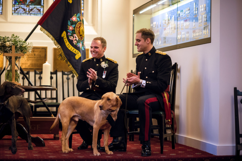Luke and Dan with their two dogs enjoying their ceremony at Sandhurst. Image credit: HollyDerrickPhotography