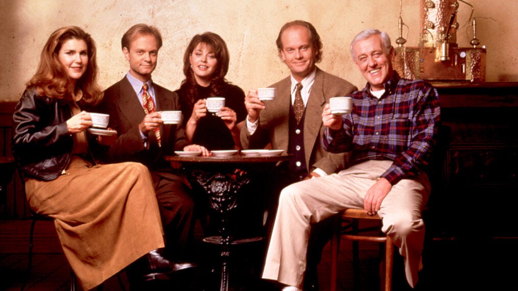 A group of five people all drinking coffee from a white coffee cup