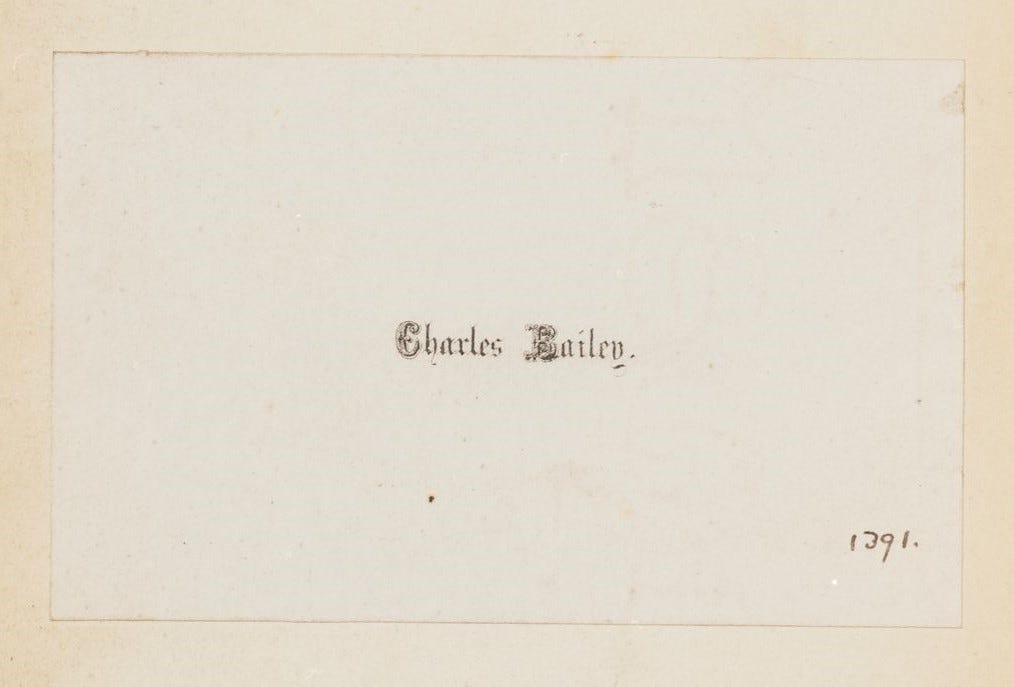 Plain book label with Charles Bailey printed in calligraphic script in the centre. The number 1391 written in ink, bottom right-hand corner.