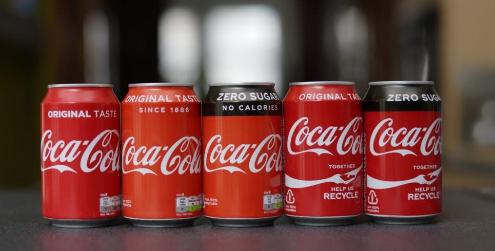 Photo of Coca Cola cans showing colour variations.