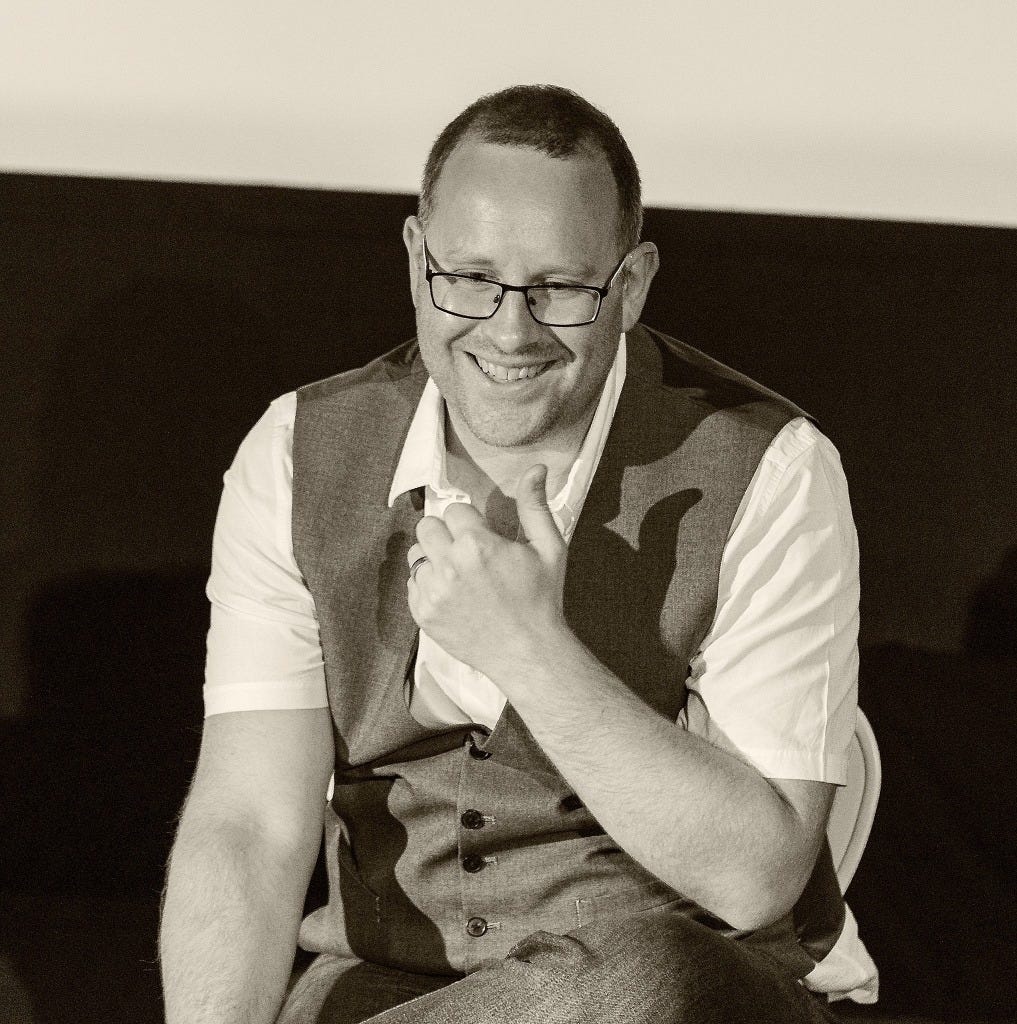 A photo of Kieran Rose, The Autistic Advocate, wearing a waistcoat and glasses