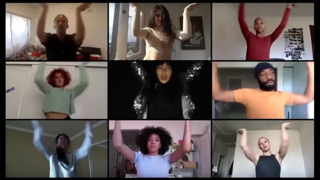 Screenshot of people on a Zoom call, all holding their arms in the air with wrists flexed