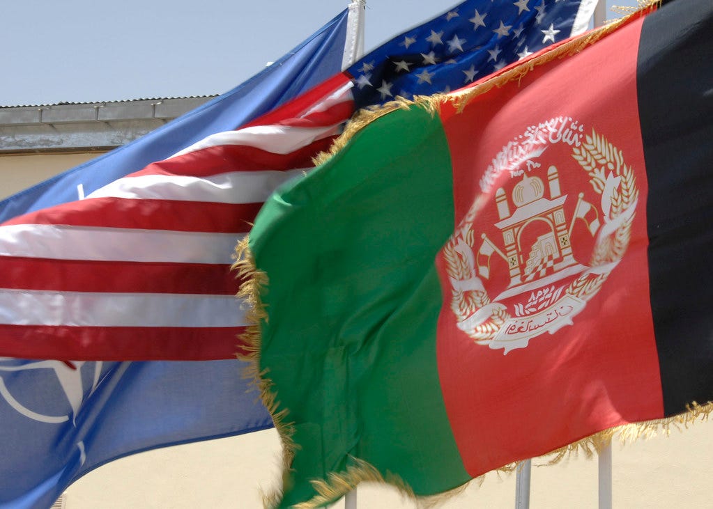 United States, Afghanistan and NATO flags flyign side by side