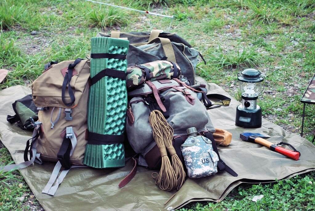 Various camping gear on a mat