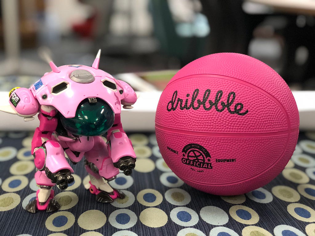 A figurine from the game, Overwatch and a mini Dribbble basketball